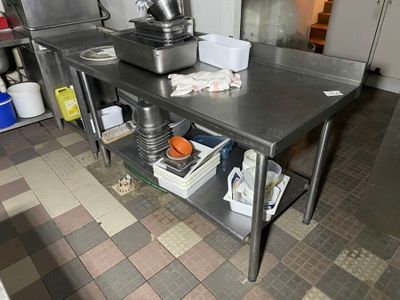 a kitchen with a table and a mixer on the counter