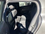 the back seat of a car with the door open and the driver ' s seat down