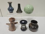 quatre vases différents exposés sur une table blanche