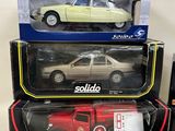 three model cars are sitting on top of each other on a table