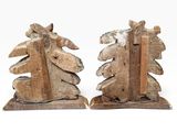 pair of wooden bookends with a carved design on them