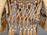 a close up of a decorative object with tassels on it