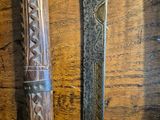 two different types of knives on a wooden table
