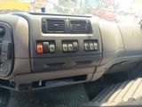 a dashboard of a truck with a lot of buttons on it