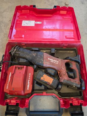 a red tool box with tools in it on the floor