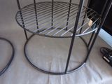 a metal shelf with a wire basket on top of it