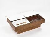 a wooden box with two cups in it on a white surface