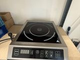 a black and silver stove top on a wooden table