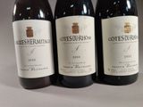 three bottles of wine sitting on top of a table next to each other