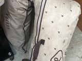a pile of luggage sitting on the floor next to a chair