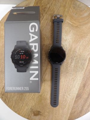 the garmin watch is sitting on top of a wooden table