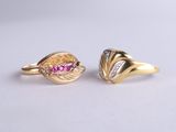 a pair of gold rings with pink sapphires and diamonds