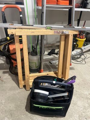 an image of a garage with tools on the floor
