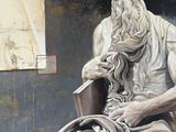 a statue of a man sitting in a chair
