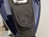 a close up of a blue motorcycle with a black seat