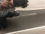 reflection of a man taking a picture of himself in a car window