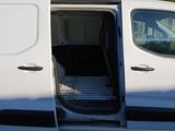 a white van with its doors open in a parking lot