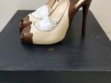 an image of a pair of high heeled shoes sitting on top of a box