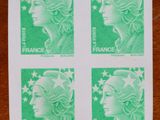 un gros plan sur quatre timbres représentant le visage d'une femme