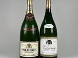 two bottles of wine sitting next to each other on a table