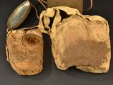 an old pair of shoes and a bag on a table