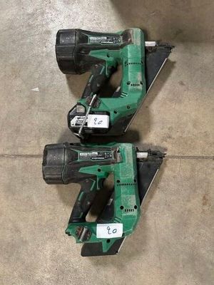 two green power tools sitting on top of a cement floor