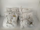 six bags of white stuff sitting on a white table
