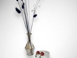a vase with flowers in it next to a vase with flowers in it