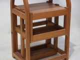 a small wooden shelf with two shelves on top of it