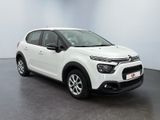a white citrole is parked in a white room