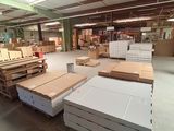 a large warehouse with a lot of boxes and pallets on the floor