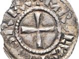 a close up of a coin with a cross on it