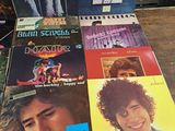 a lot of records on a table with a picture of a man