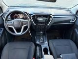 a dashboard of a car with a steering wheel and dashboard controls