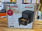 an air fryer sitting on top of a wooden table in a warehouse