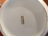 a close up of a white bowl on a table