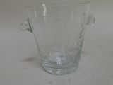 a glass vase with a handle on a table