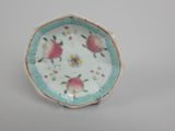 a small plate with flowers on it sitting on a table