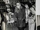 several black and white photos of a man in a suit and woman in a fur coat and a woman in a fur coat and a woman in a fur coat