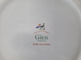 a white plate with a bird on it sitting on a table
