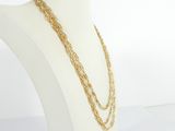 a close up of a mannequin with a gold chain necklace on it