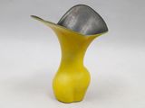 yellow and silver vase with a black top