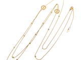 a set of three gold necklaces and a bracelet