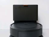 an image of a robotic vacuum cleaner on a white surface