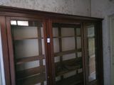 a room that has a glass door and a wooden cabinet