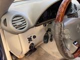 a steering wheel and dashboard of a car with wood trims