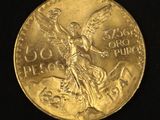 a close up of a gold coin with an angel on it