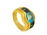 a close up of a gold ring with a blue stone