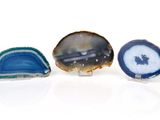 three pieces of blue and white agate on a white surface