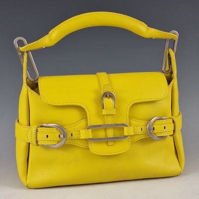 a yellow handbag with a metal handle and two metal handles